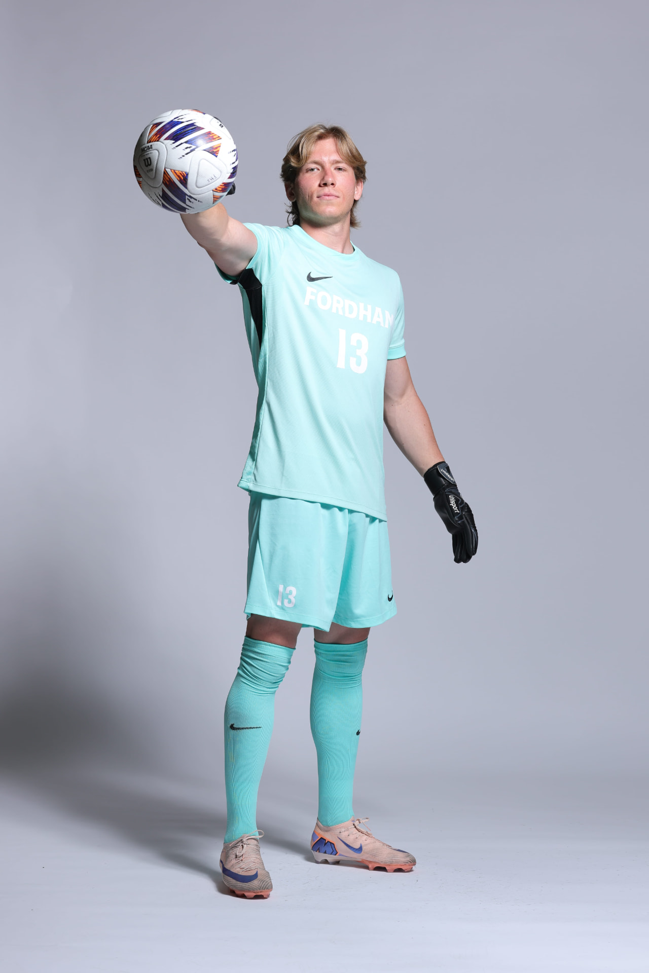 Edoardo Grandi in Fordham kit reaching out with a soccer ball